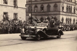 Hitler and Mussolini parade through the streets of Vienna after the successful Anschluss of Austria.