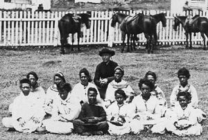 Father Damien, seen here with the Kalawao Girls Choir during the 1870s, took on the role of priest and doctor to lepers in settlement colonies.