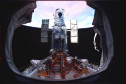  Hubble on the payload bay just prior to release with beautiful glowing color of earth in the background. SM3B�: STS-109.