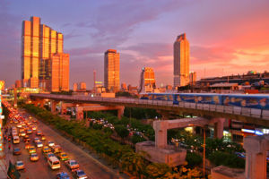 The Bangkok Skytrain at sunset on Thanon Narathiwat Ratcha Nakharin with the Empire Tower in the background.