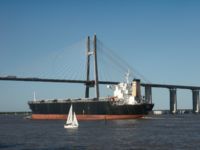 A cargo ship in front of the Rosario-Victoria Bridge.