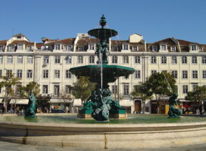 Rossio Square with bronze fountain and the typical Pombaline style.