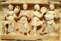 Hellenistic culture in the Indian subcontinent: Greek clothes, amphoras, wine and music (Detail from Chakhil-i-Ghoundi stupa, Hadda, Gandhara, 1st century AD).