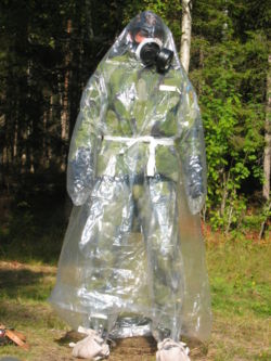 A Swedish Army soldier wearing a chemical agent protective suit (C-vätskeskydd) and his protection mask (skyddsmask 90).