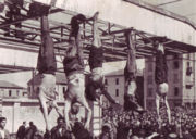 Benito Mussolini, Claretta Petacci and other Fascists hung by their feet after being executed.