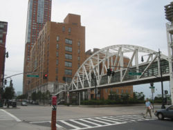 View of the Stuyvesant building from the corner of West and Chambers Streets. The Tribeca Bridge is in the foreground.