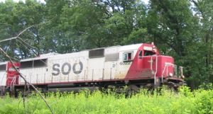 Soo Line 6022, an EMD SD 60, pulls a train through Wisconsin Dells, WI, June 20 2004.