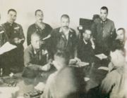 Lieutenant-General Yamashita (seated, centre) thumps the table with his fist to emphasise his demand for unconditional surrender. Lieutenant-General Percival sits between his officers, his clenched hand to his mouth. (Photo from Imperial War Museum).