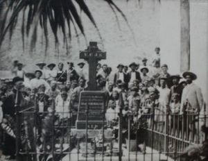 Following Father Damien's death the lepers of Molokai gathered around his grave in mourning.