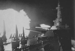 Washington fires upon Japanese battleship Kirishima during the battle on November 14-15, 1942.  The low elevation of the gun barrels is due to the relatively close range of the two adversaries.