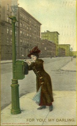 Woman putting letter in a mailbox, United States, 1909