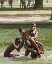 Children bathing in a pond.