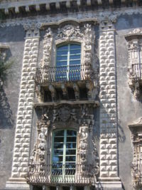 Illustration 2:University of Catania, designed by Vaccarini and completed by 1752, exemplifies typical Sicilian Baroque, with putti supporting the balcony, wrought iron balustrades, decorated rustication and two-tone lava masonry.