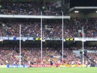 Australian rules football goal posts - the two tall central posts are the goal posts, and the two shorter outer posts are the behind posts.