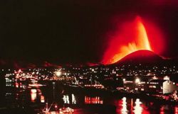 Lava fountains tower over Heimaey in the early stages of the Eldfell eruption