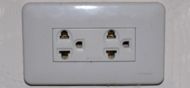 A standard grounded Thai outlet supporting all common 2 pin plugs and also earthed American plugs