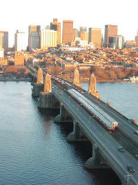 Longfellow Bridge across the Charles River, with two MBTA Red Line trains. The Beacon Hill neighborhood is in the background.