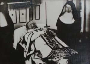 Father Damien died on April 15, 1889. This (reversed) photograph shows Mother Marianne Cope standing beside his body.