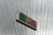 From the arch hangs a sign saying "Bienvenidos a Tijuana" (Welcome to Tijuana)