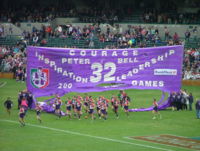 Before the start of each AFL games, players run through a banner constructed by supporters.