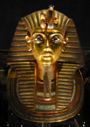 The iconic gold burial mask of Tutankhamun, inlaid with turquoise, lapis lazuli, carnelian and coloured glass.