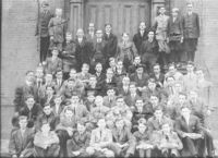 The 1911 school body. Headmaster Charles H. Weller is first on the left in the third row and George Lovell is 7th from the left in the top row (he would go on to be headmaster from 1916–1953).