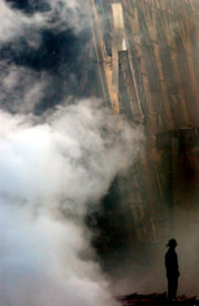 A solitary firefighter stands amid the rubble and smoke in New York City. Days after the Sept. 11 attack, fires still burned at the site of the World Trade Center.