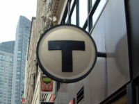 An MBTA sign at the Chinatown stop on the Orange Line. The MBTA rapid transit system serves urban Boston and surrounding suburban areas.