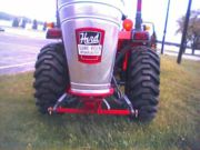 Broadcast seeder mounted to a Kubota Compact Utility Tractor