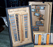 The inside of an early 20th century button accordion with a closeup of the reeds.