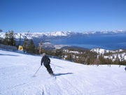 Man skiing slope overlooking Lake Tahoe