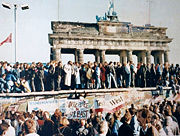 Germans begin standing on top of the wall, 1989; it would begin being physically torn apart in the upcoming days.