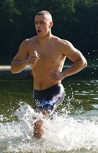 U.S. Marine emerging from the swim portion of a triathlon.