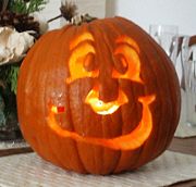 A jack-o'-lantern lit by a candle inside.