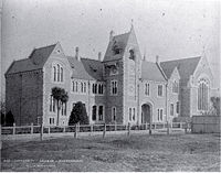 Canterbury College, designed by  Benjamin Mountfort in 1877, is dominated by a central clock tower, with a medieval style great hall to the right.