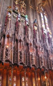 Swords, helms and crests of Knights of the Thistle above their stalls in the Thistle Chapel. Lady Marion Fraser's helm and crest are second from the left