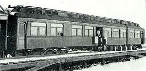 The Thymallus, a "fish car" of the Montana State Fish Service, circa 1910. The attendants are loading stainless steel milk cans filled with fish onto the car.