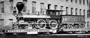 Atlantic, Mississippi and Ohio Railroad #87, delivered 1873-10-27 from the Mason Machine Works of Taunton, Massachusetts.  This is a 5 ft (1524 mm) gauge 4-4-0 with 54 in (1.37 m) drivers.  Shown during delivery on flatcars due to gauge incompatibility.  Note the elaborate ornamentation.  #87 is a wood-burner with a spark-arresting Radley-Hunter type stack.