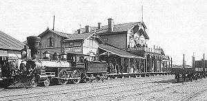 A Hanko-Hyvink�� railway Baldwin 4-4-0 of 1872 vintage in front of the station building in Hanko in 1893.