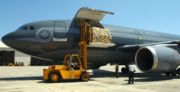 United States Navy personnel unload Canadian relief supplies from a Canadian Air Force transport aircraft in Pensacola, Florida.