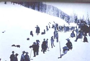 Chinese railroad workers perform their duties in the snow.