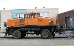 Heavy work trains are hauled with sizeable tractors such as this old (1966) “Duplex”. Traction is effected through the rubber-tired wheels, and guidance through the retractable flanged wheel. This tractor can also operate on the road.