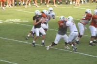 A quarterback searching for opportunity to throw a pass.