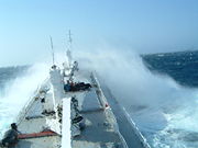 A ship's hull endures harsh conditions at sea, as illustrated by this reefer ship in bad weather.