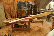 A World War I wooden aircraft propeller on a workbench.