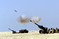 A 155�mm M198 howitzer firing a shell.