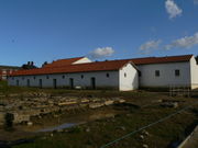 Reconstructed barracks of a Castra Hiberna, or "winter camp". Each doorway provides entry to a large room, the sleeping quarters of one contubernium, or "squad" of about 10 men.