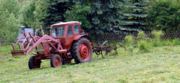 A Belarusian-made tractor being used to farm