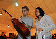 Rollins signing an autograph while on a United Service Organizations tour in Iraq in 2006.