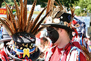 Morris dancers with black painted faces, traditional along the border with Wales.